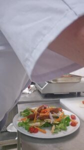 La même assiette de keftas végétales, mâche et crudités, posée sur le plan de travail de la cuisine